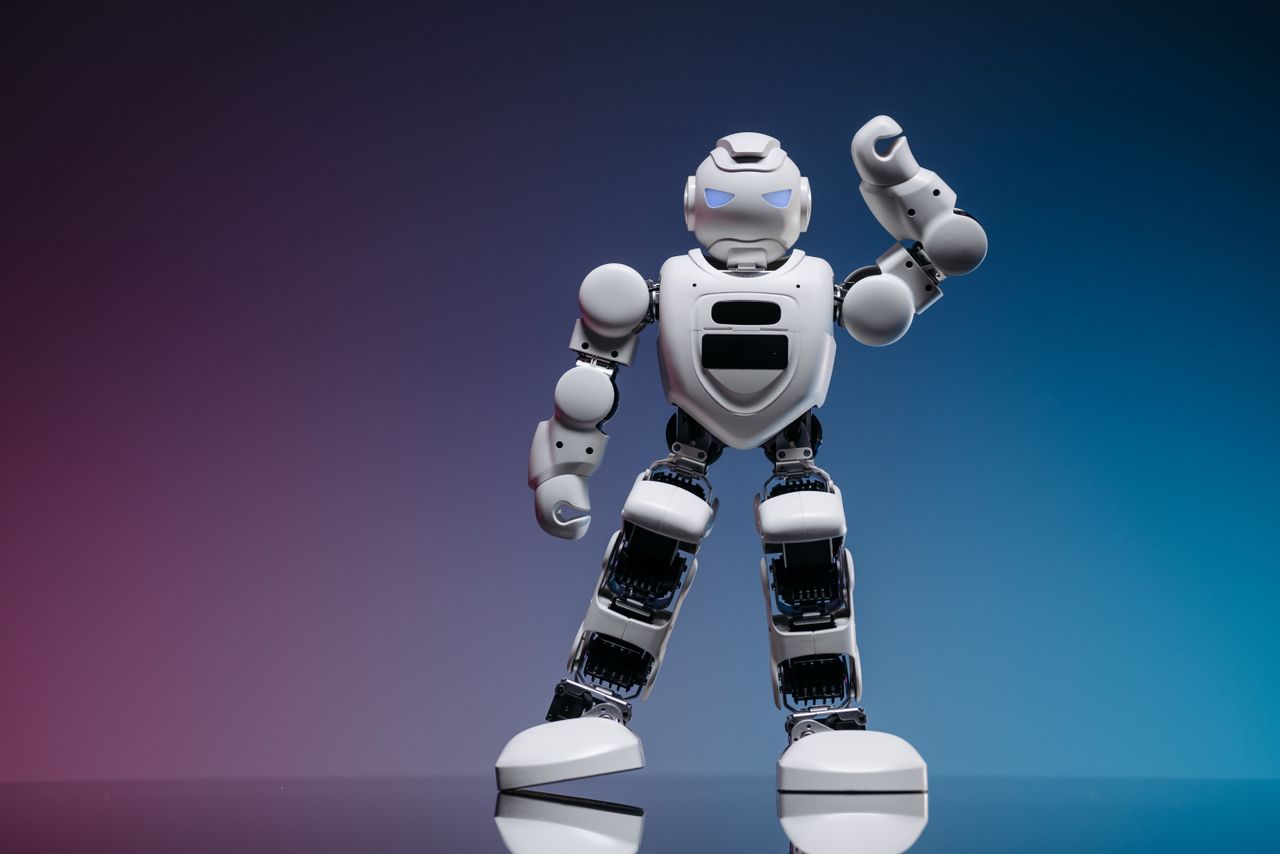 Mastering the First Impression: Your intriguing post title goes here A sleek white robot in a studio setting against a gradient background, showcasing modern robotics.